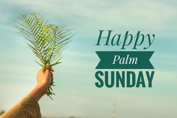 Happy Palm Sunday concept with text design. On background of  young woman holding fern or palm leaf...