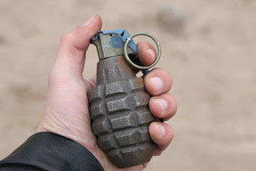 american combat grenade in hand