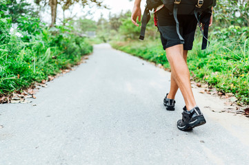 Digital nomadic man walking the forest road