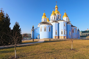 Scenic landscape view of Saint Michael's Golden-Domed Monastery ("Mykhailiv'skyj Sobor") against blue sky at sunny day. Sacred christian building. Kyiv, Ukraine