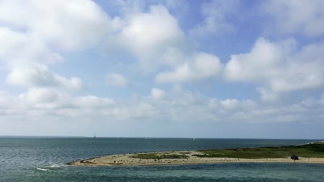Two guys with black SUV on beach strong water current sailboats in distance summer extreme wide II
