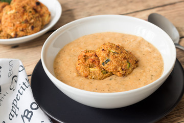 Vegetarian meal with vegetable cream and millet patties