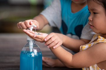 Child Hands Using Wash Hand Sanitizer Gel Pump Dispenser, Selected Focus