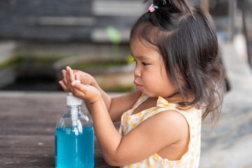 Child Hands Using Wash Hand Sanitizer Gel Pump Dispenser, Selected Focus