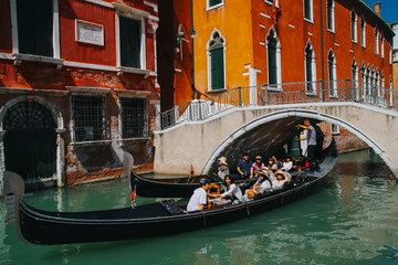 VENICE, ITALY -APRIL 8: Gondolas and tourists on April 8, 2011 in Venice, Italy. Venice has an average of 50,000 tourists a day and was the 26th most visited city in the world.