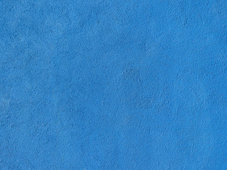 Seamless texture. The plastered wall is painted with blue paint. Rough surface