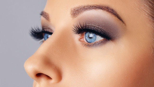 Woman eyes with long eyelashes and smokey eyes make-up. Eyelash extensions, makeup, cosmetics, beauty