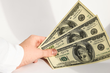 dollar currency, hand holding dollars cash on the black background