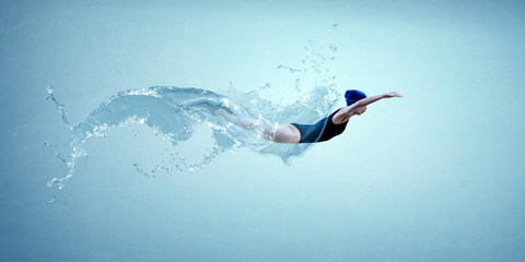 Professional man swimmer on a wave