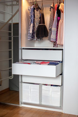 Vertical storage of clothing. Clothing folded for vertical storage in the linen drawer. Nursery. Sliding wardrobe. Room interior. Neatly folded clothes in chest of drawers.