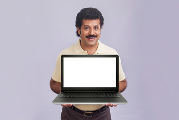 Man in happy mood holding a laptop in his hands. 