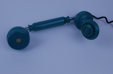  the telephone receiver lies on a blue background