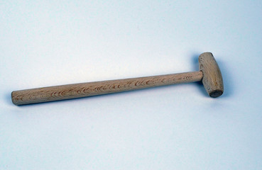  wooden hammer lies on a white background