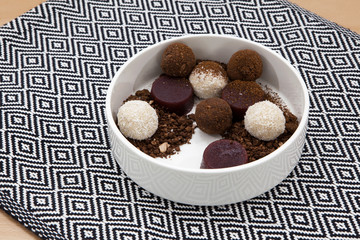 Homemade energy balls with cocoa and coconut, chocolate truffles and fresh berry marmalade. Healthy food for children and vegan, sweets substitute. Copy spase.