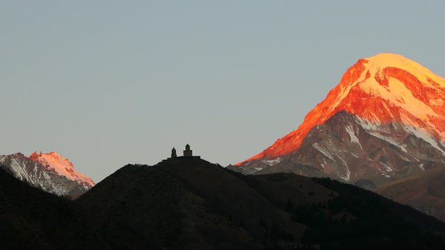 sunrise Tsminda Sameba Church and red mountain 