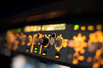 Close up shot of the Flight Control Unit of an Airbus A320 in flight, cockpit view at night