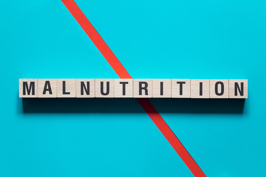 Malnutrition word concept on cubes