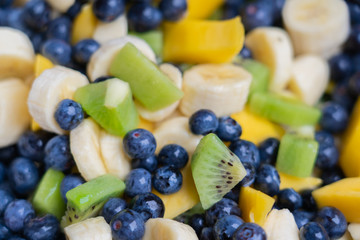 Fruit salad with fresh blueberries, bananas, kiwi and mango