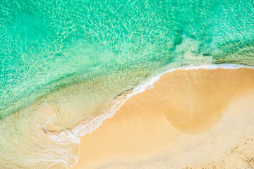 Fototapeta na wymiar Top view aerial drone photo of ocean seashore with beautiful turquoise water and sea waves. Caribbean resort. Vacation travel background.