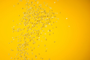 Concept of flying yellow raw italian pasta on yellow background with unfocused elements.