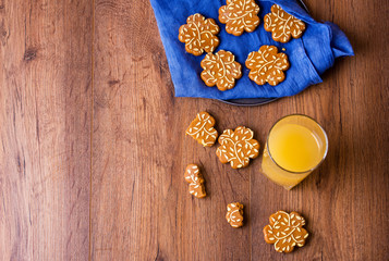 Delicious cookies with orange juice on a wooden table.