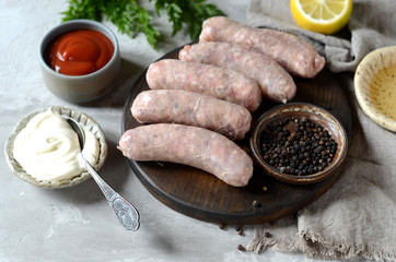 Raw homemade sausages from turkey (chicken) with different sauces