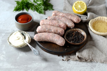 Raw homemade sausages from turkey (chicken) with different sauces