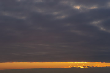 Beautiful clear, morning sky at sunrise, natural background. Soft gradient from orange to blue.