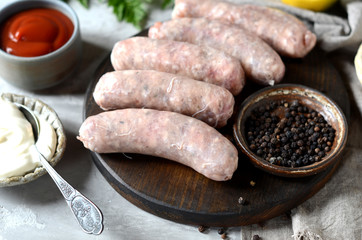 Raw homemade sausages from turkey (chicken) with different sauces