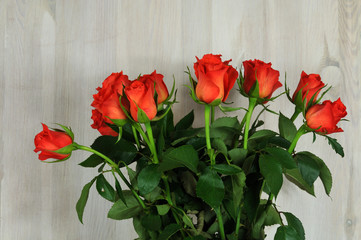 Fototapeta na wymiar red rose flowers on a wooden background