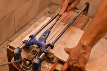 Tiler cutting ceramic with machine. Concept of building and home renovation