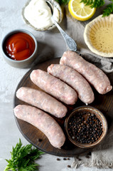 Raw homemade sausages from turkey (chicken) with different sauces
