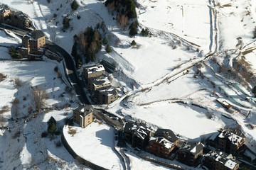 Aerial view of the road in winter, road surrounded by trees, car in winter. Rural winter area