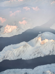 Fototapeta na wymiar Aerial view of snow covered mountains and fjords in East Greenland, Maniitsoq