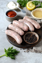 Raw homemade sausages from turkey (chicken) with different sauces