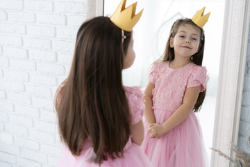 Happy little princess look in to the mirror. © opolja