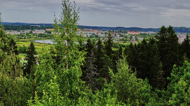 Panorama of the city from a height.Panoramic view of the city of Sortavala from a hill in a city park: a forest of conifers, traces of volcanic lava, rocks and volcanic rocks. Russia, Karelia
