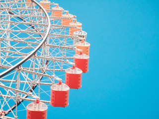 Ferris Wheel Over Blue Sky Background