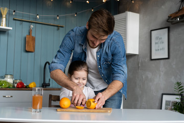 family, eating and people concept - happy father and daughter having breakfast at home