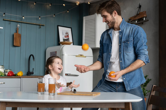 family, eating and people concept - happy father and daughter having breakfast at home
