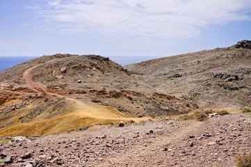 Hike pathways with red and yellow sand near the Atlantic Ocean (Madeira, Portugal, Europe) 