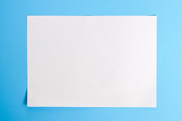 white torn paper with blue background, ready for design