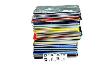 Stack of credit cards against white background debt in front of cards.