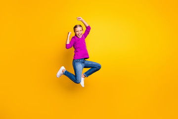 Fototapeta na wymiar Full length body size view of her she nice attractive lovely cheerful cheery girl jumping rejoicing attainment having fun pass test exam isolated on bright vivid shine vibrant yellow color background