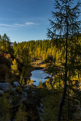 Fototapeta na wymiar Small lake in Valley of the Triglav Lakes throw trees