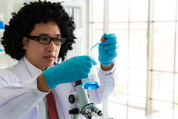 Scientist studies properties fatty acids using microscope and laboratory equipment in a medical laboratory. COVID-19. COVID Coronavirus