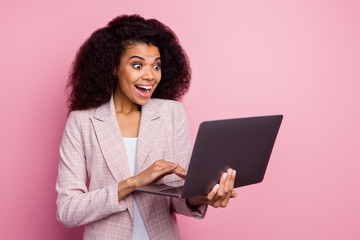 Photo of beautiful dark skin lady open mouth hold notebook hands read email colleagues successful project investment wear checkered blazer isolated pastel pink color background