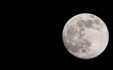Naklejka na ściany i meble Closeup of a Full Moon in a Black Sky