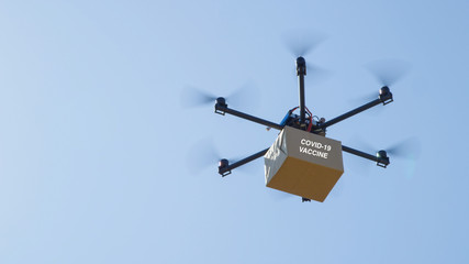 CLOSE UP Unmanned helicopter carries a brown package containing COVID-19 vaccine