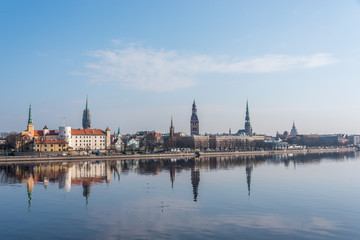 Naklejka premium Cityscape of Riga Latvia with Reflections on a Quiet Still River